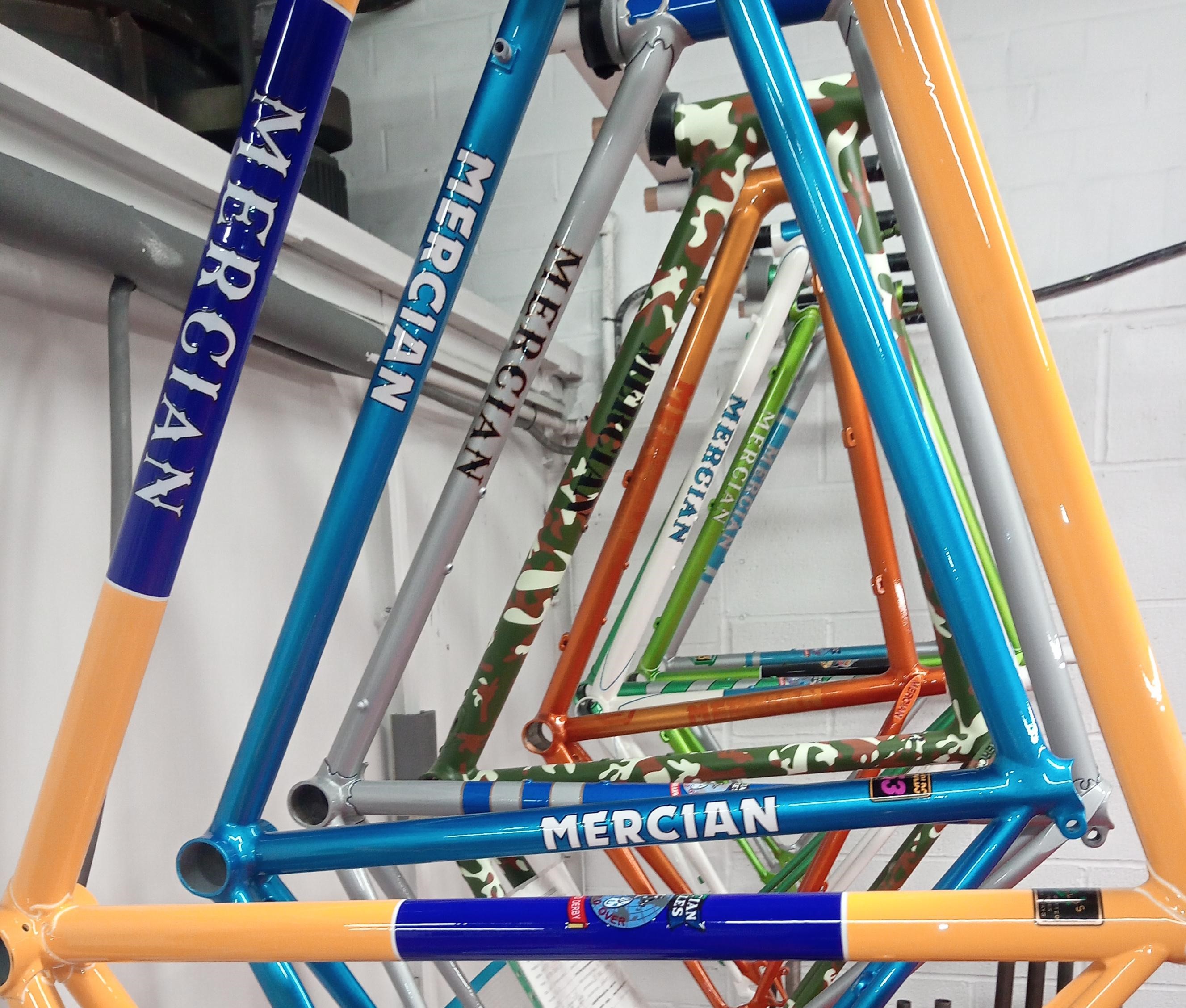Repsrayed Mercian Cycles bike frames hanging in the paint shop